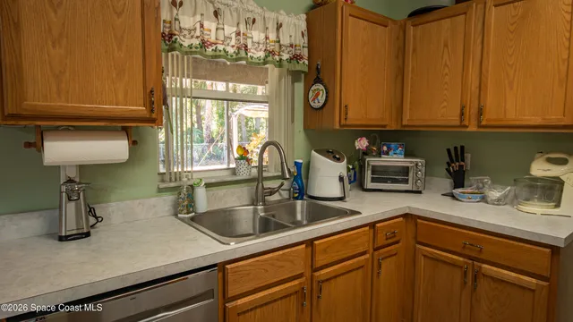 a kitchen with cabinets and window