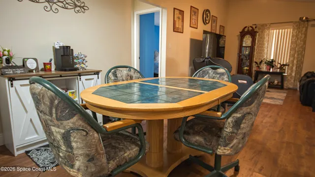a dining room with furniture and wooden floor