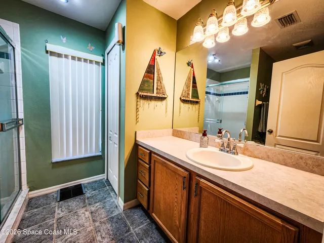 a bathroom with a double vanity sink and a mirror