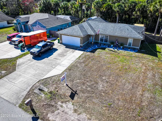 a aerial view of a house with table and chairs