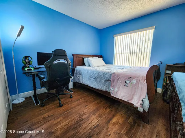 a living room with a bed furniture and a window