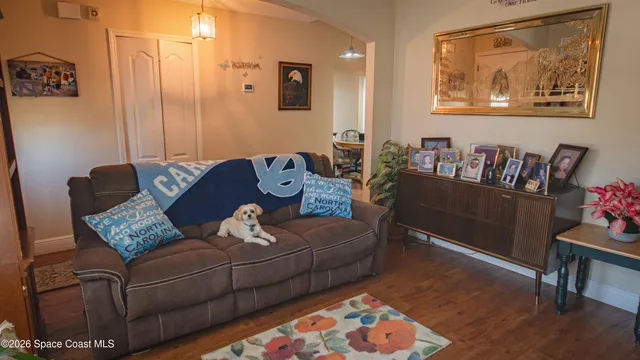 a living room with furniture and wooden floor