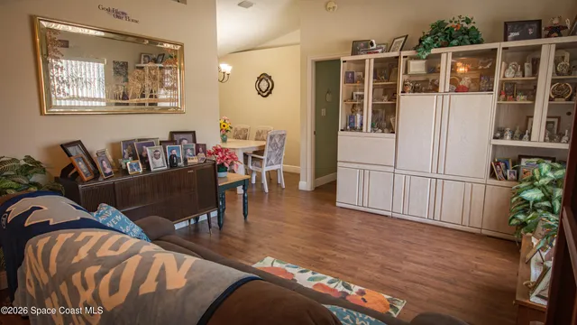a living room with furniture windows and wooden floor