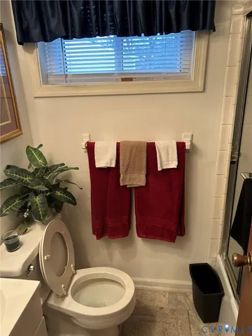 a view of a dining room with furniture a chandelier and wooden floor