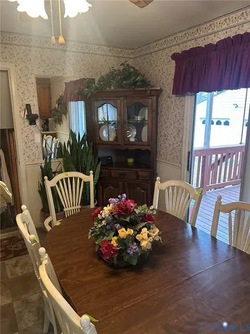 a view of a dining room with furniture a chandelier and wooden floor