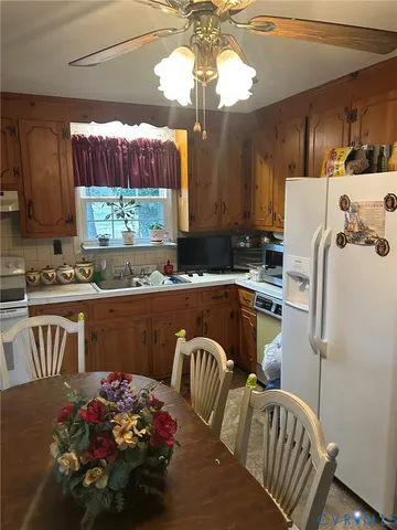 a kitchen with stainless steel appliances granite countertop a sink dishwasher a refrigerator and a stove