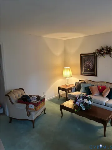 a living room with furniture and a lamp