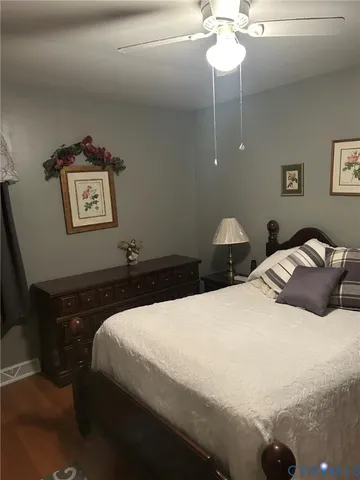 a bed sitting in a bedroom next to a window and a lamp