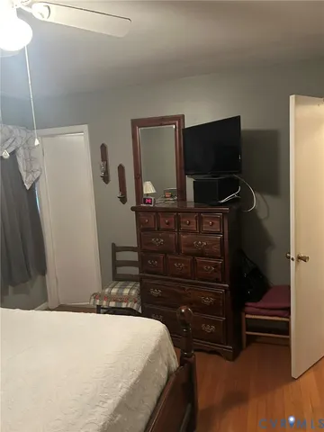 a bedroom with a bed and flat screen tv