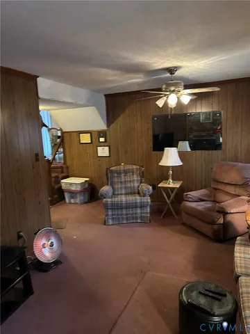a living room with furniture and a lamp