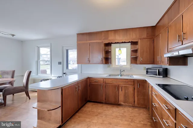 a kitchen with a sink stove and cabinets