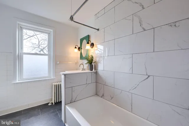 a bathroom with a bathtub and window