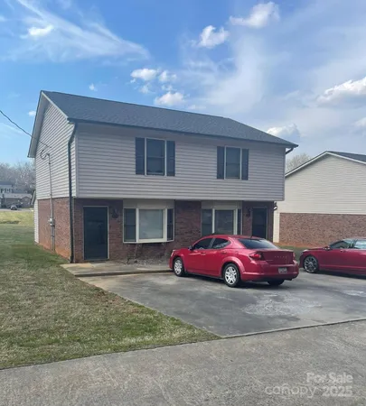 a red car parked in front of a house