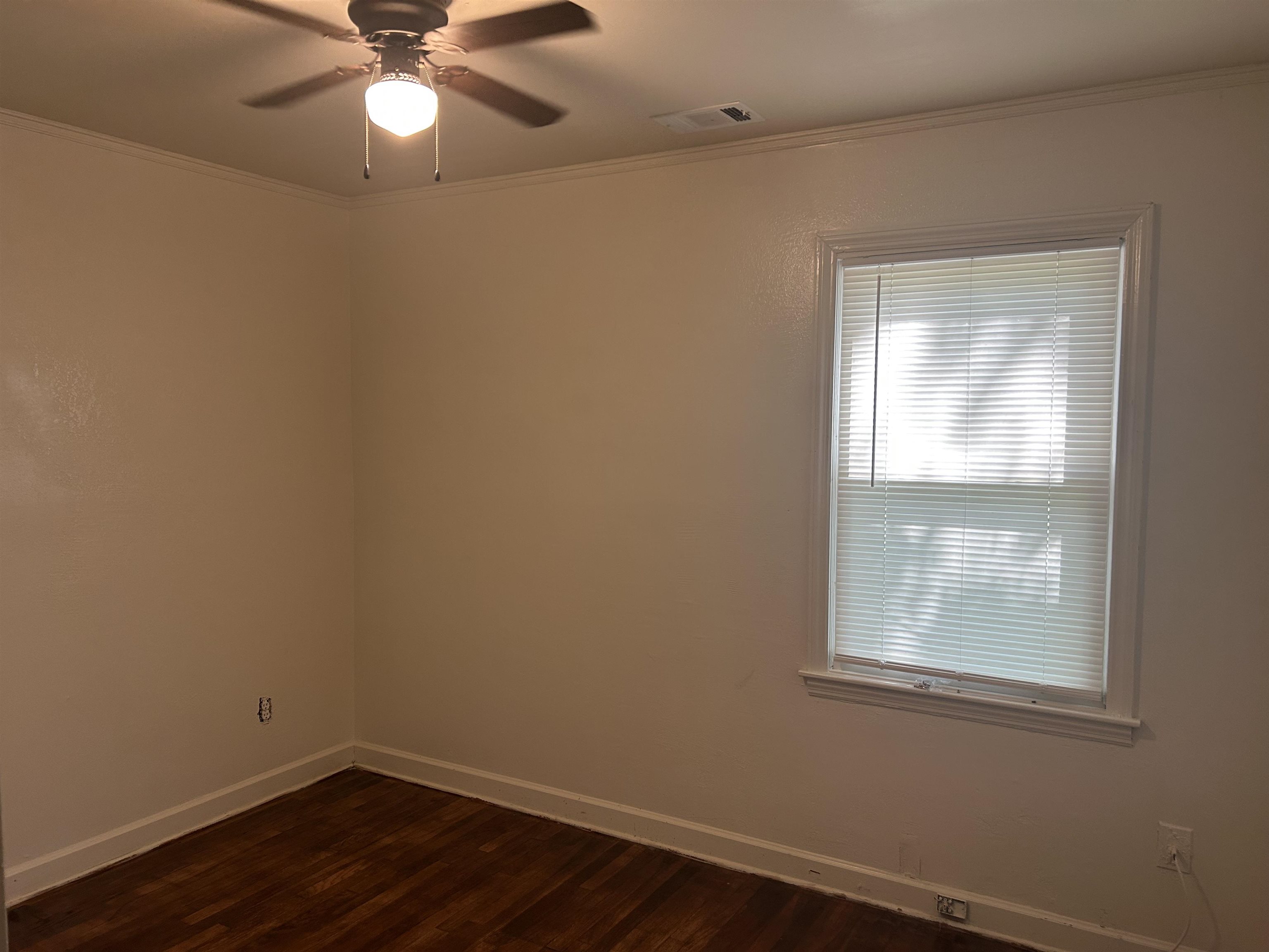 904 North Ball Road Memphis, TN 38106 - Photo 9 of 12 Room featuring wood-finish flooring, a window with blinds, and a ceiling fan with integrated lighting