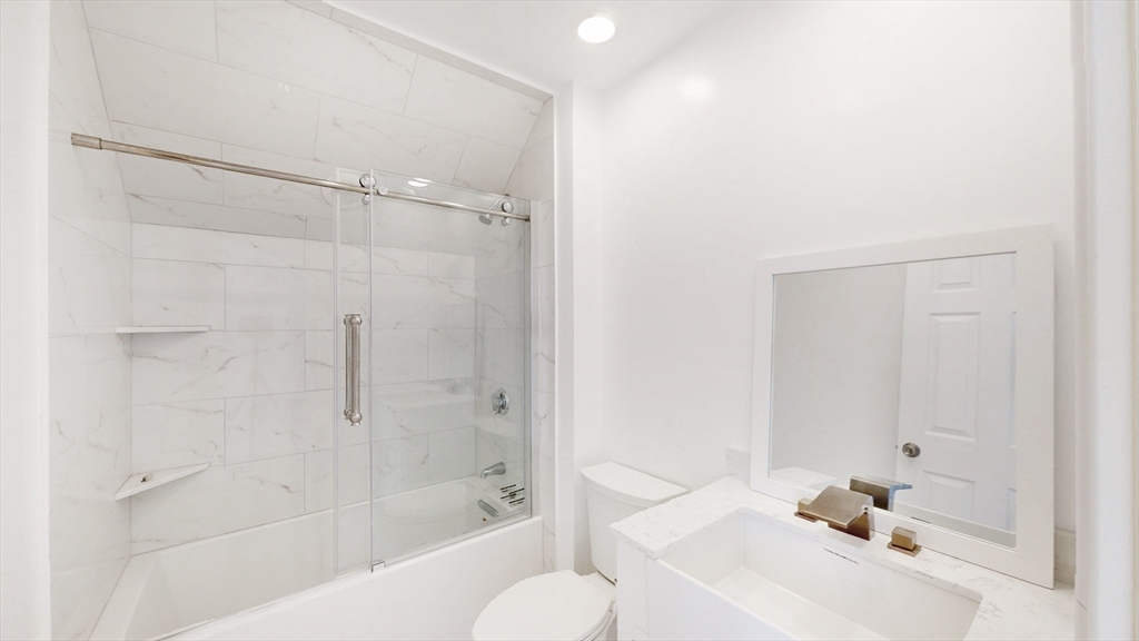 48 Rockwell Street, Unit 1 Malden, MA 02148 - Photo 12 of 34 a bathroom with a bathtub and a shower