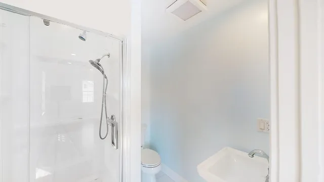 a bathroom with a shower and toilet