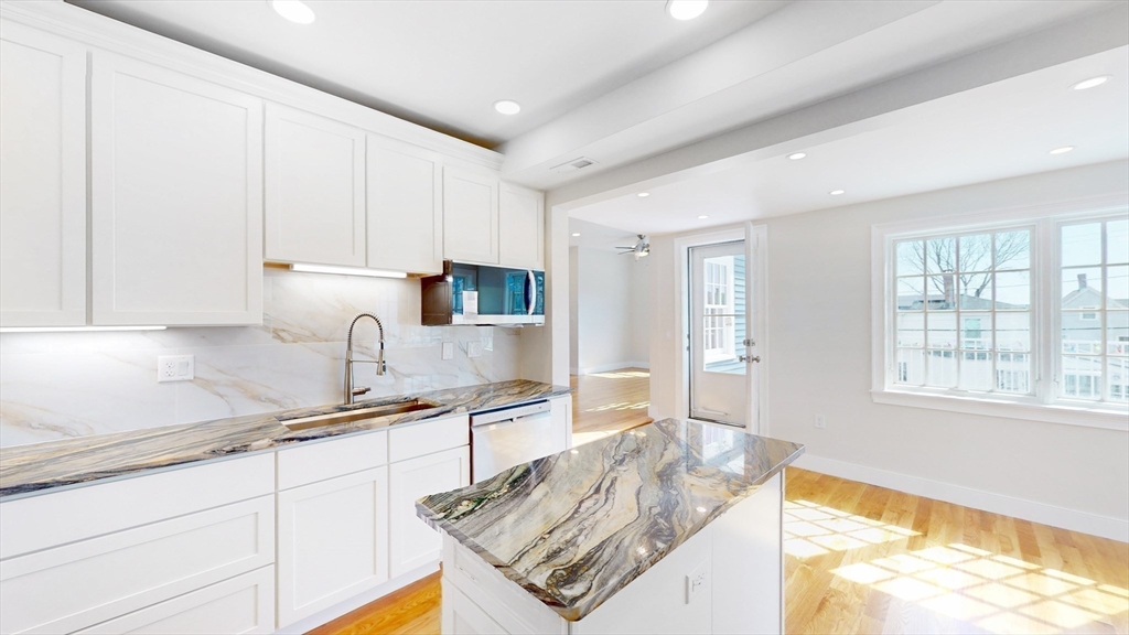 48 Rockwell Street, Unit 1 Malden, MA 02148 - Photo 17 of 34 a kitchen with stainless steel appliances granite countertop a sink stove and cabinets