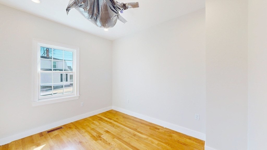 48 Rockwell Street, Unit 1 Malden, MA 02148 - Photo 23 of 34 a view of a room with wooden floor and a window