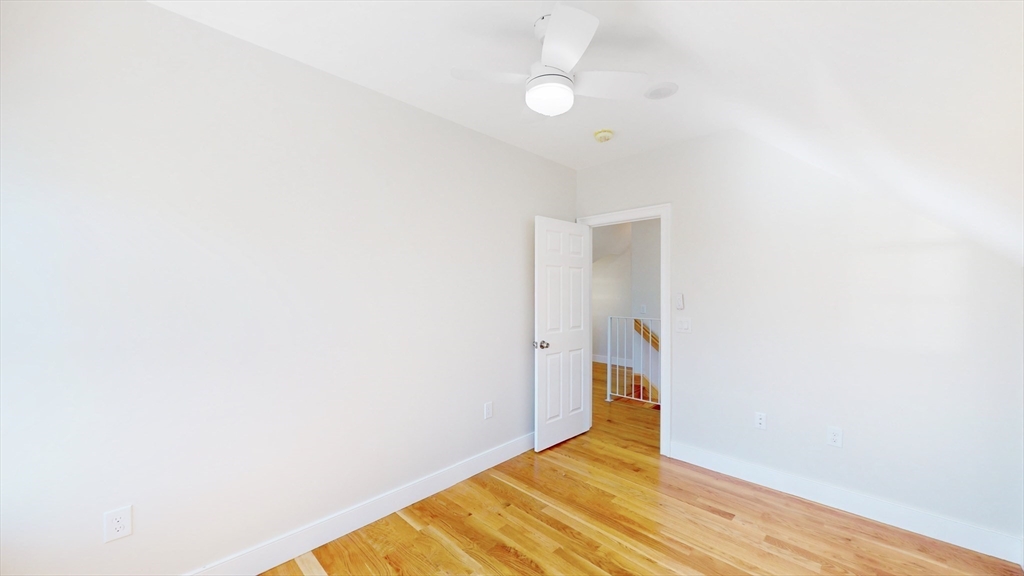 48 Rockwell Street, Unit 1 Malden, MA 02148 - Photo 30 of 34 a view of an empty room with wooden floor