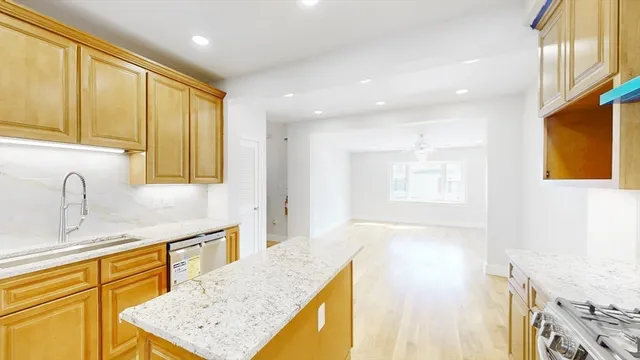 a bathroom with a granite countertop sink and a bathtub