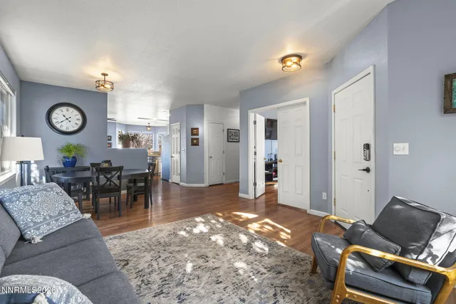 a living room with furniture and view of kitchen