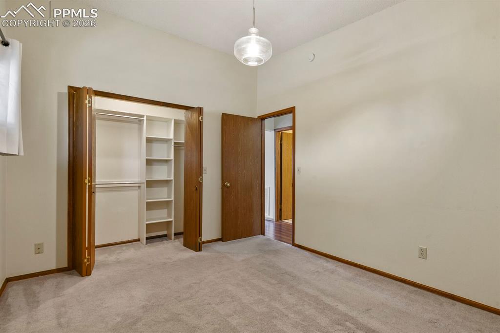 1130 Fontmore Road, Unit C Colorado Springs, CO 80904 - Photo 19 of 27 an empty room with closet and a ceiling fan