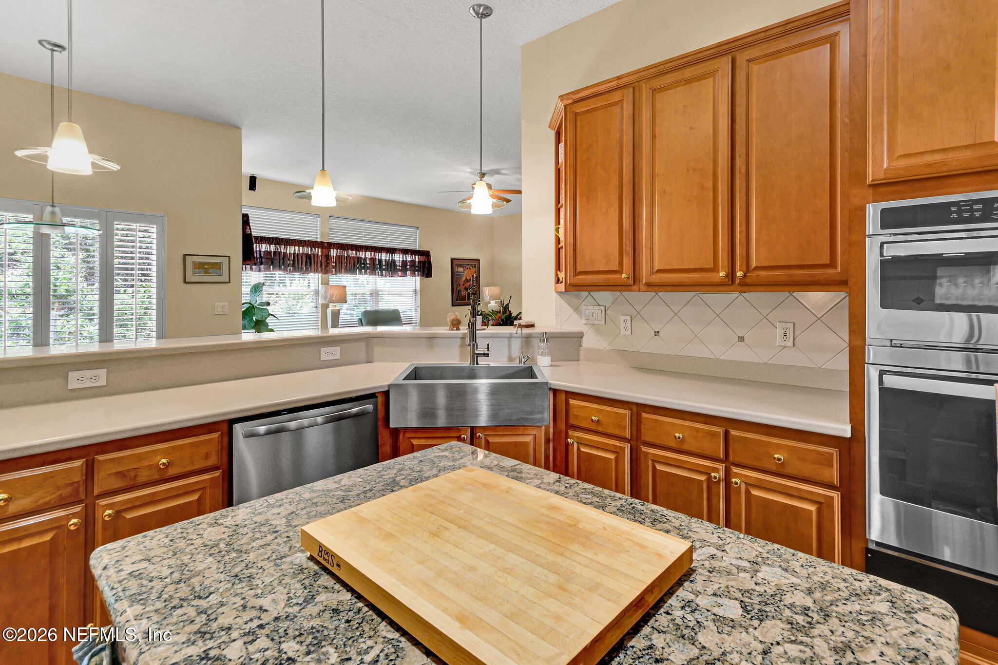5950 West Shores Road Orange Park, FL 32003 - Photo 15 of 42 a kitchen with a sink cabinets and wooden floor