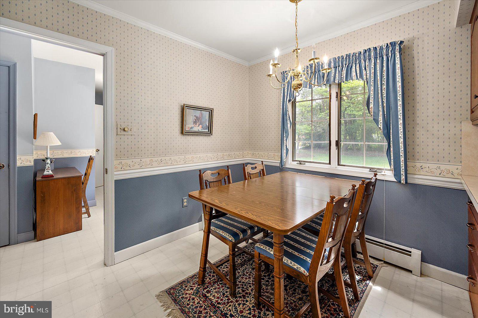 701 Riverside Pines Court Salisbury, MD 21801 - Photo 19 of 81 a dining room with a table chairs and a chandelier