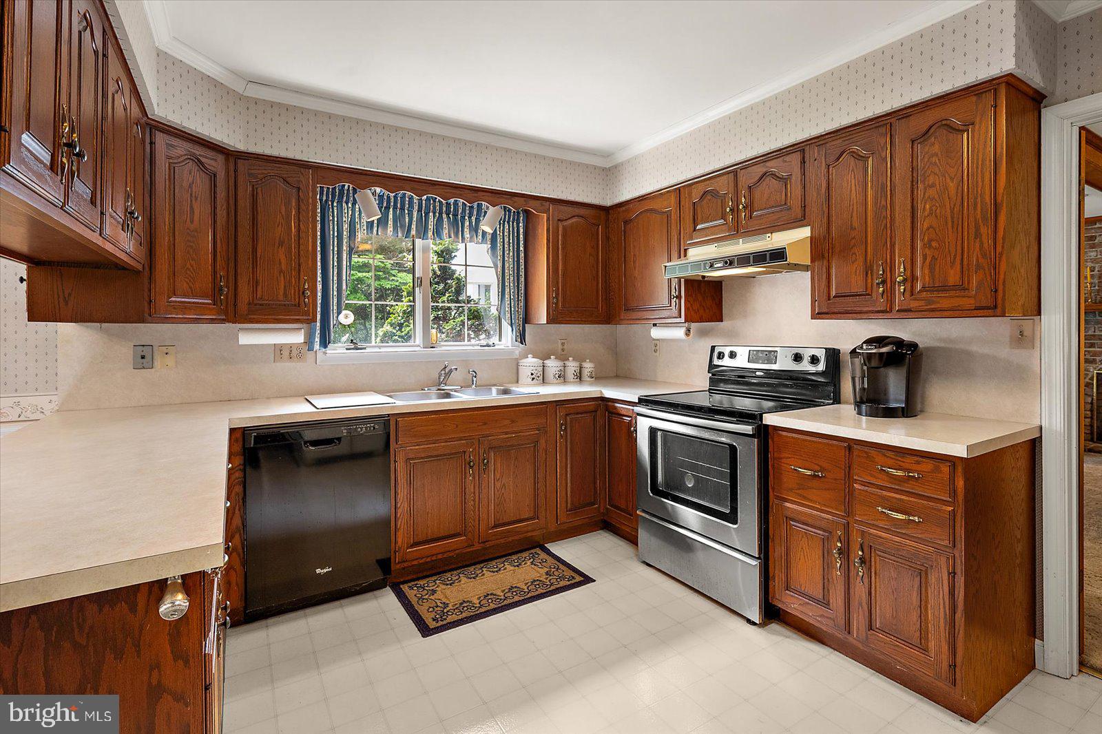 701 Riverside Pines Court Salisbury, MD 21801 - Photo 32 of 81 a kitchen with a sink cabinets appliances and a window