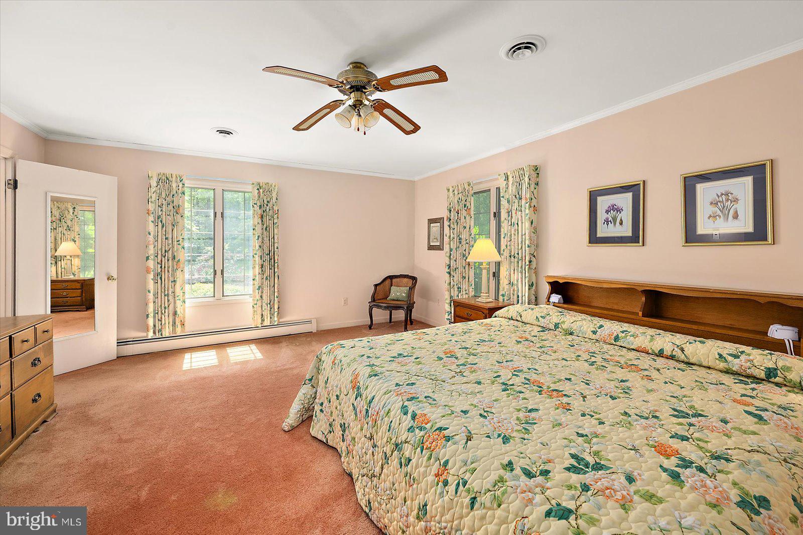 701 Riverside Pines Court Salisbury, MD 21801 - Photo 46 of 81 a spacious bedroom with a large bed and a chandelier