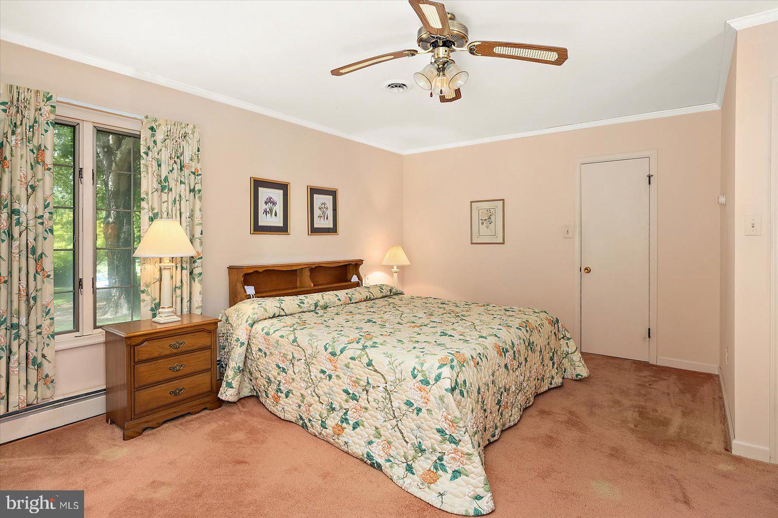 701 Riverside Pines Court Salisbury, MD 21801 - Photo 47 of 81 a bedroom with a large bed and a chandelier