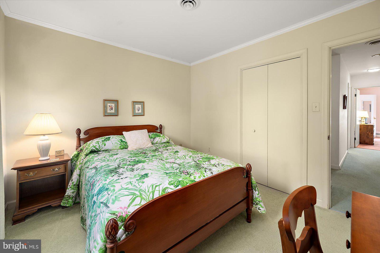 701 Riverside Pines Court Salisbury, MD 21801 - Photo 54 of 81 a bed sitting in a bedroom next to a lamp