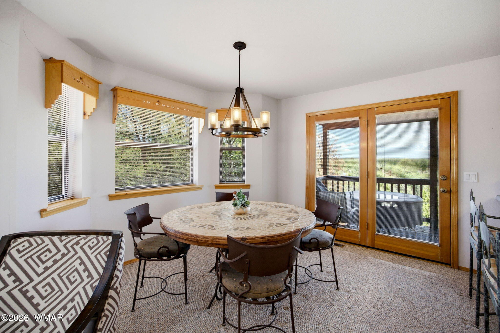 2806 Sky Hawk Drive Overgaard, AZ 85933 - Photo 12 of 43 a dining room with furniture a chandelier and wooden floor