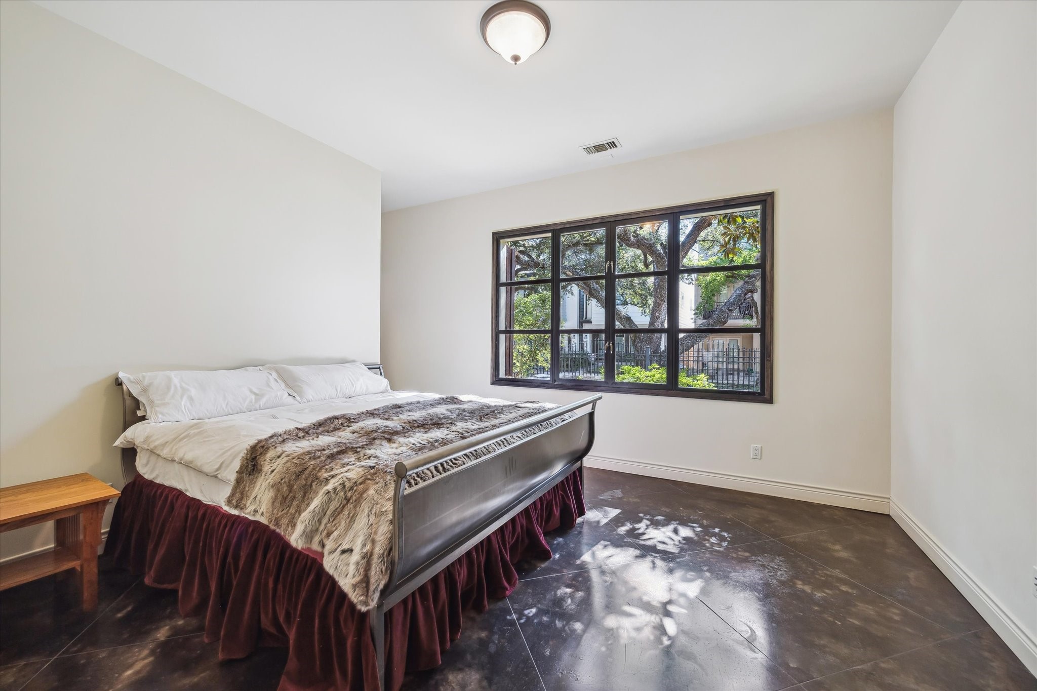 4320 Dickson Street Houston, TX 77007 - Photo 35 of 47 a bed sitting in a bedroom next to a window