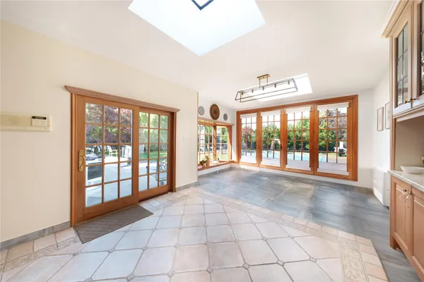 a view of an empty room with a fireplace and a large window