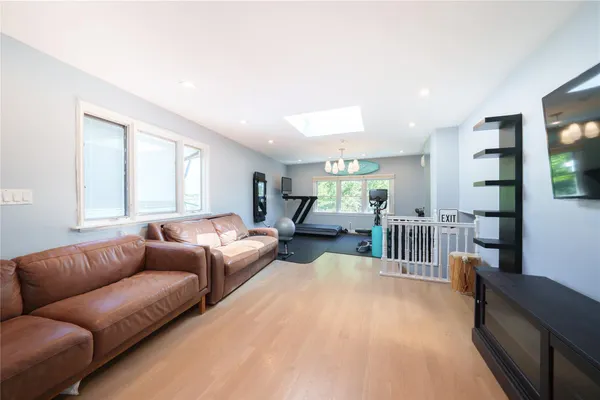 a living room with furniture fireplace and a large window