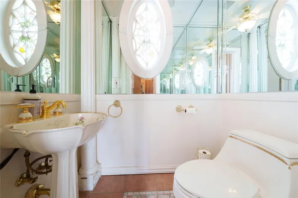 a bathroom with a sink a mirror and a toilet