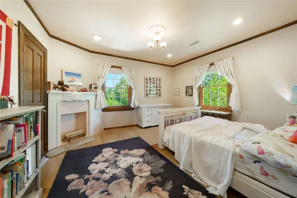 a bedroom with a bed next to a large window with the outer view