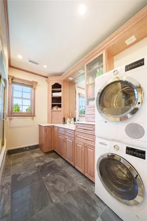 a kitchen with a sink a stove and cabinets