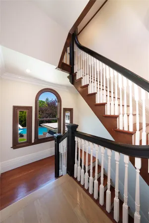 a view of entryway and hall with wooden floor