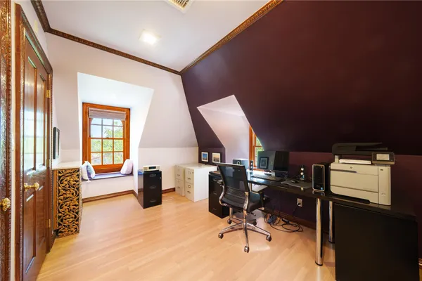 a view of a workspace with furniture and a window