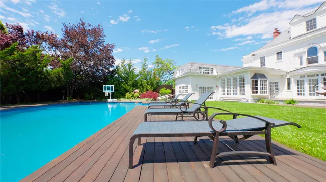 a view of a house with pool porch and chairs