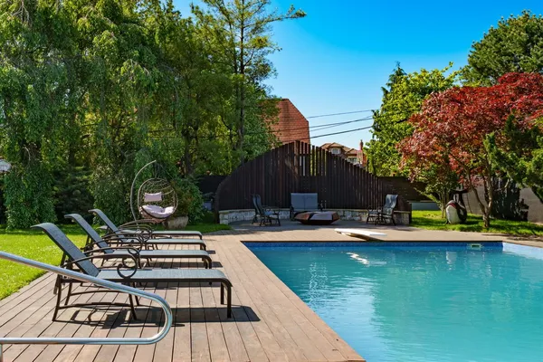 a view of a house with pool and sitting area