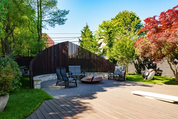a backyard of a house with a table and chairs