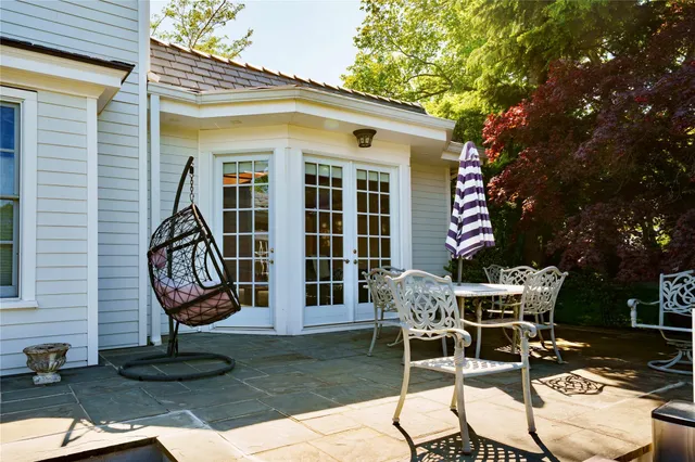 a view of a house with backyard and sitting area