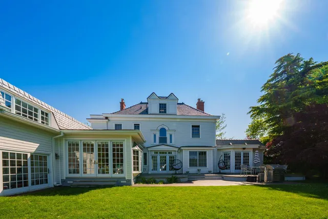 a front view of a house with swimming pool having outdoor seating