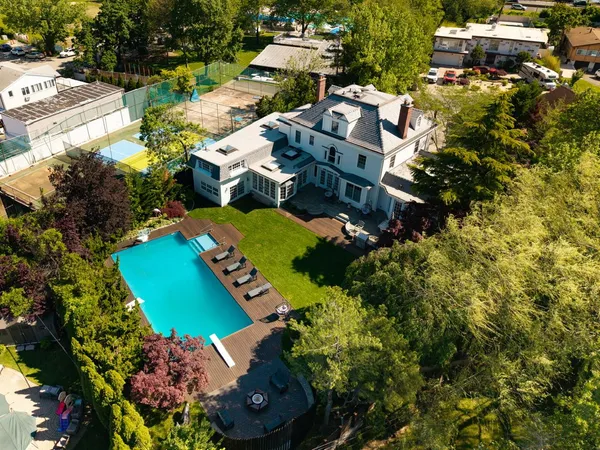 an aerial view of a house with a garden and swimming pool