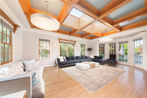 a large bedroom with a large bed and large windows