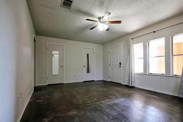 a view of a park with large trees