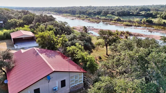 an aerial view of a house with a lake view